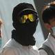 A secondary-school student in Hong Kong’s Wanchai district wears goggles and a face mask in support of protesters.
